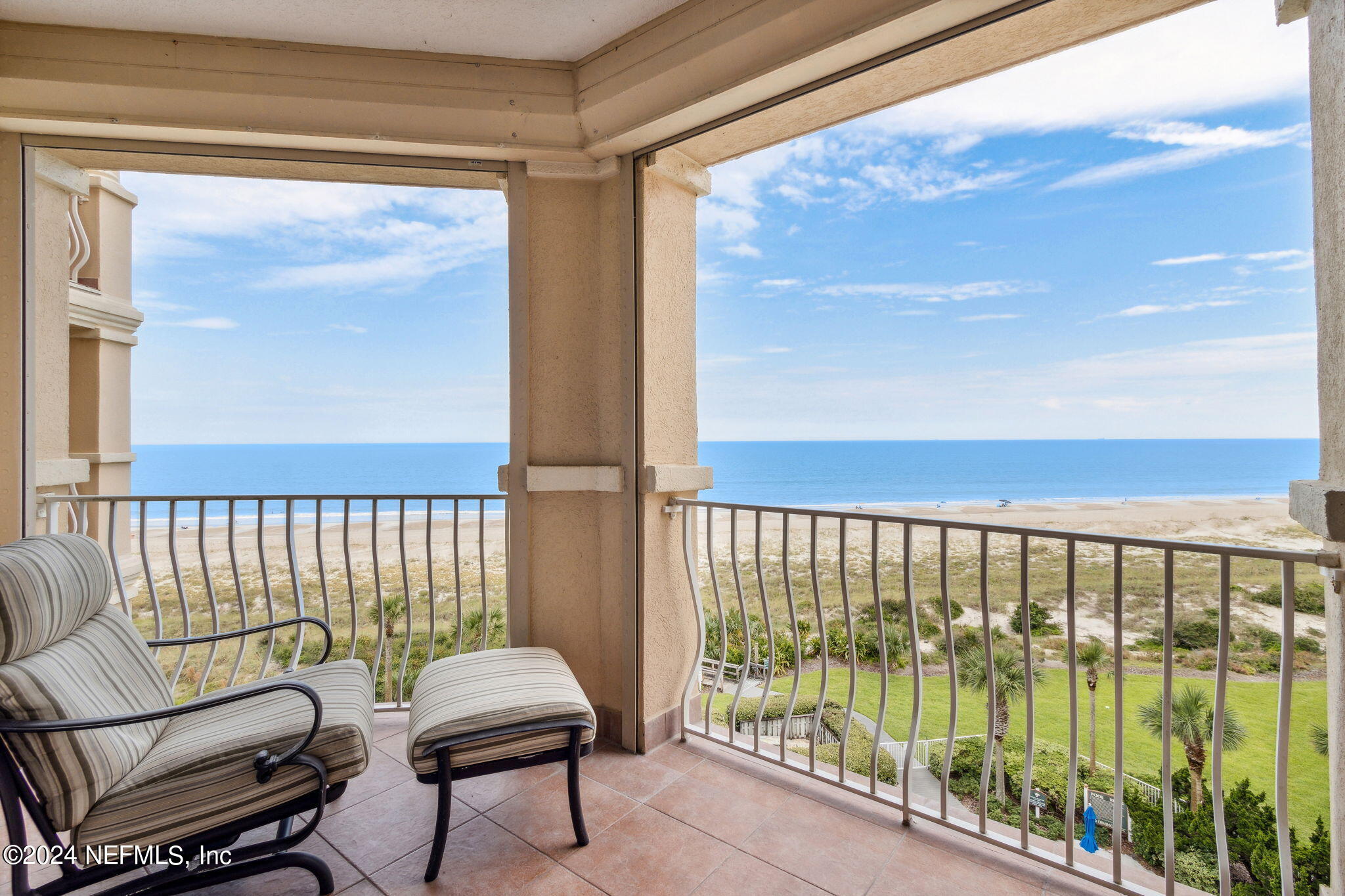 a balcony with table and chairs