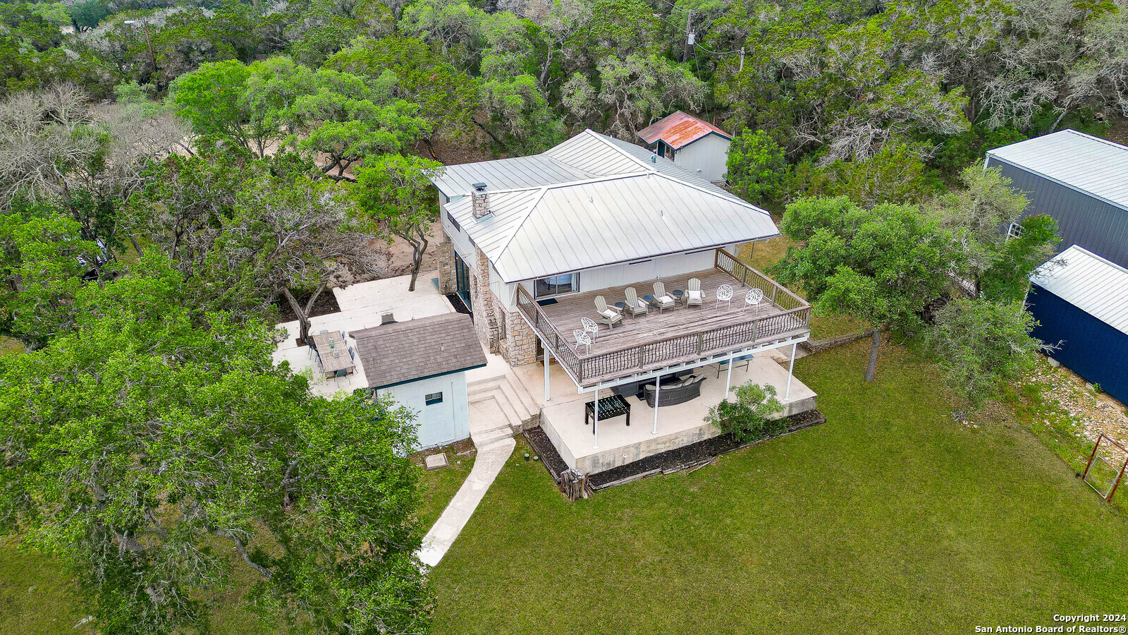 an aerial view of a house with chairs