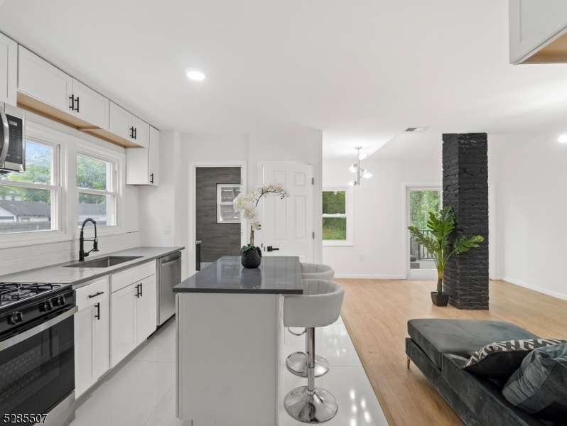 a kitchen with stainless steel appliances granite countertop a sink and a stove