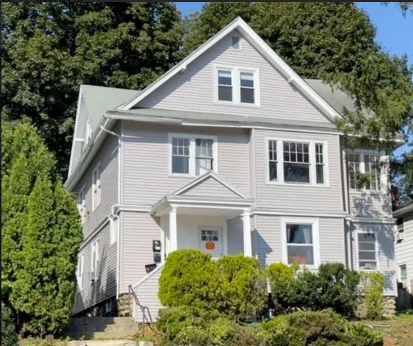 a front view of a house with a yard