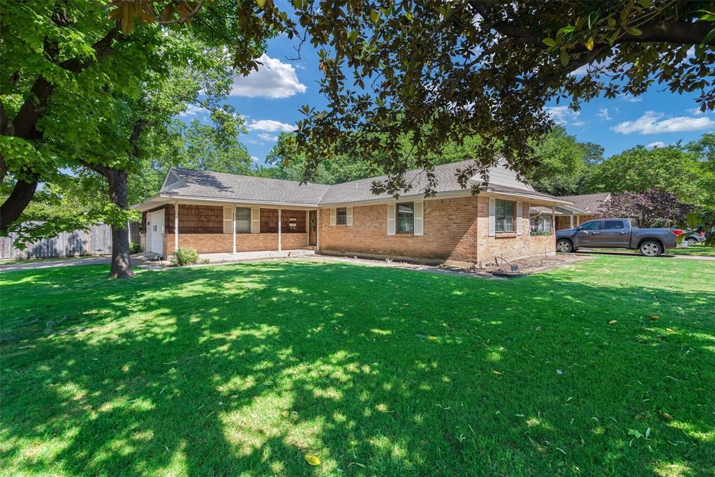 a view of a house with a backyard and a patio