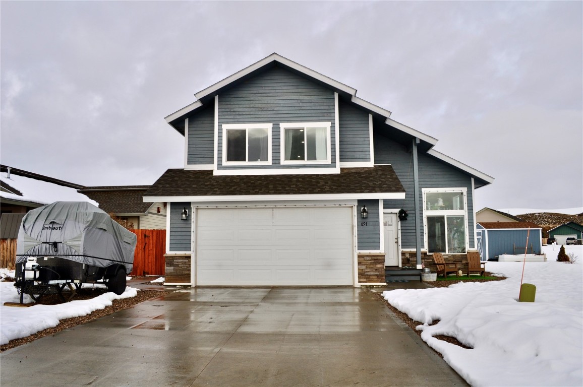 a front view of a house with cars parked