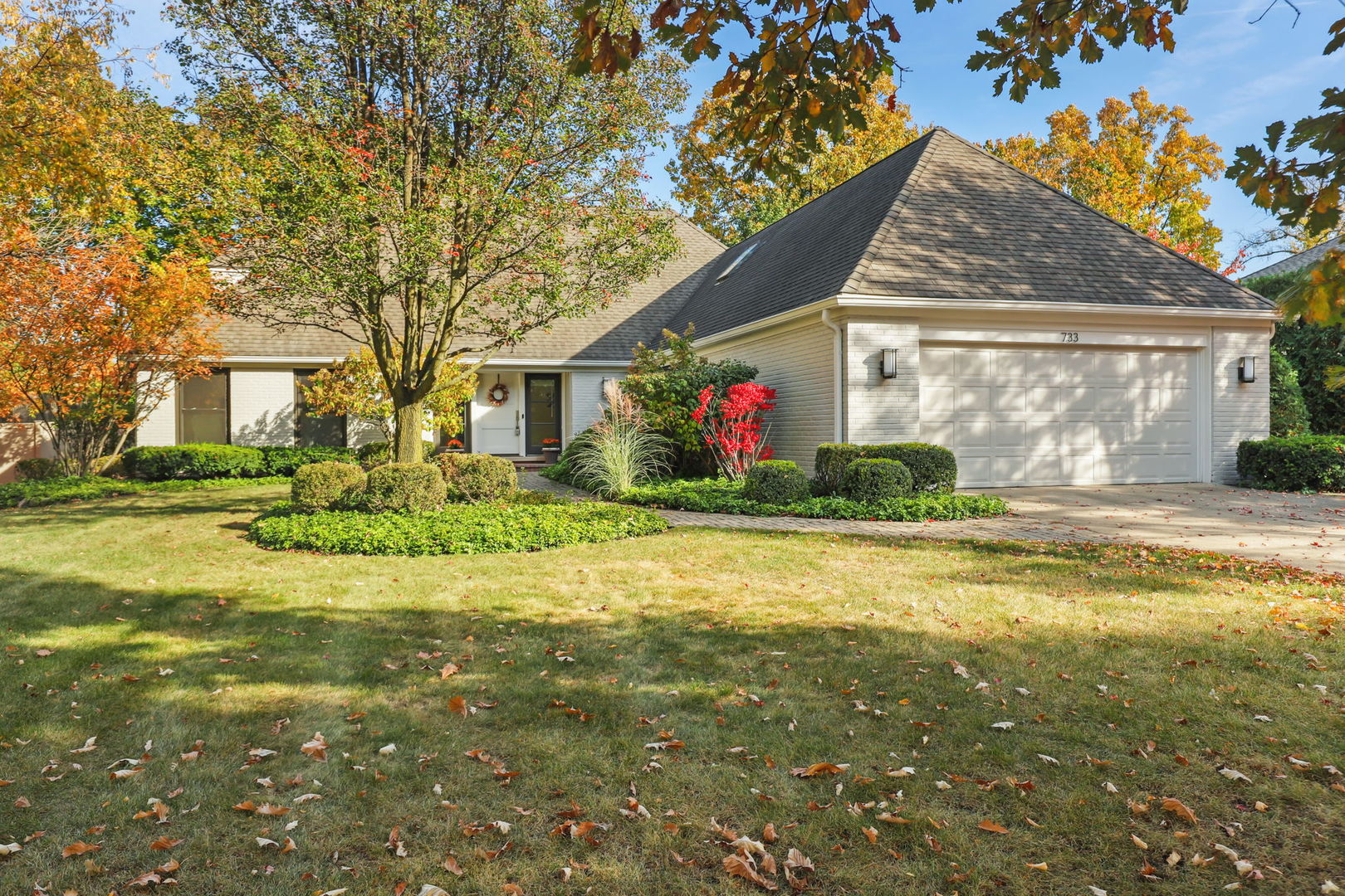 a front view of house with yard and green space