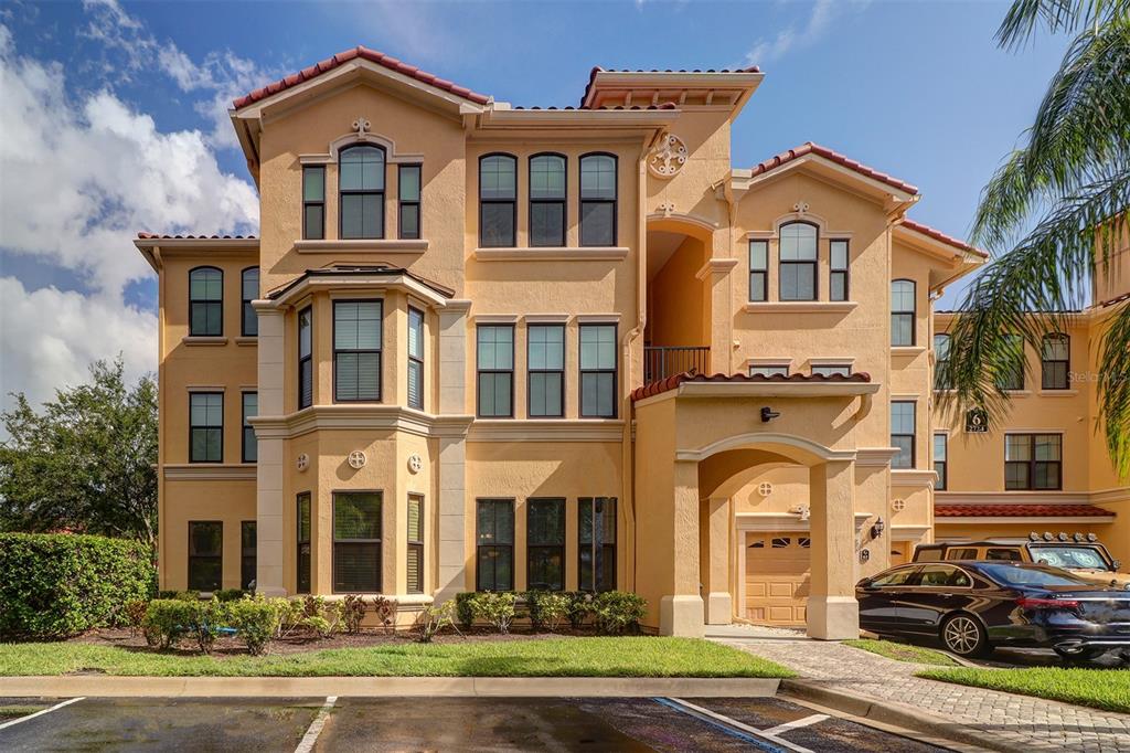 a front view of a residential apartment building with a yard