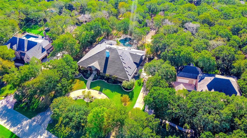 an aerial view of a house with a yard and garden