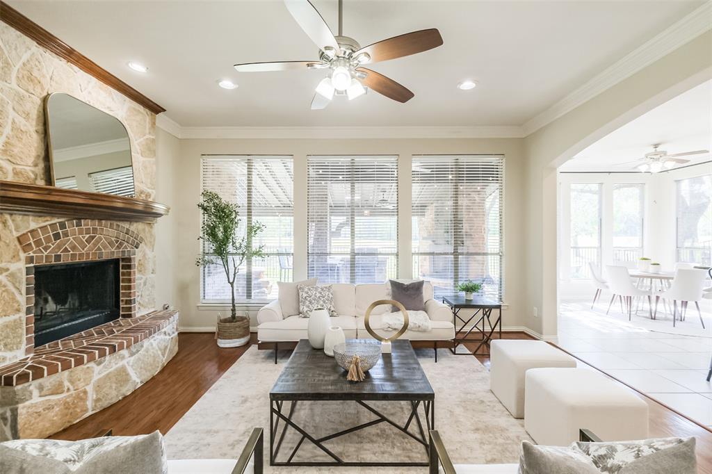 Beautiful family room with warm wood floors, large sunny windows and a stone and brick fireplace!