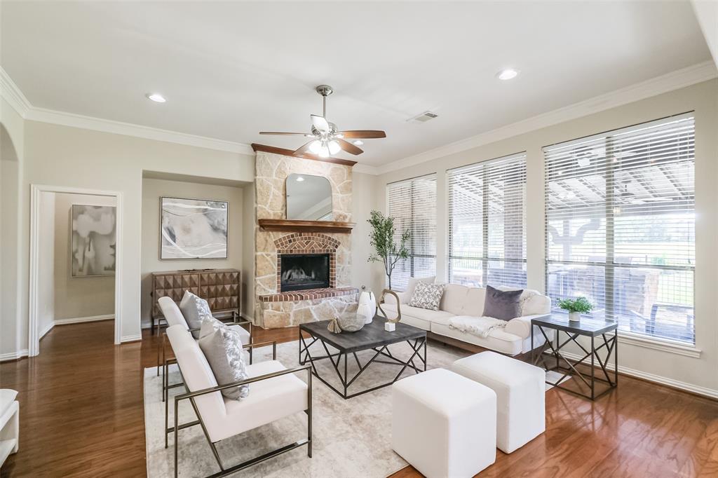 a living room with furniture a fireplace and a large window