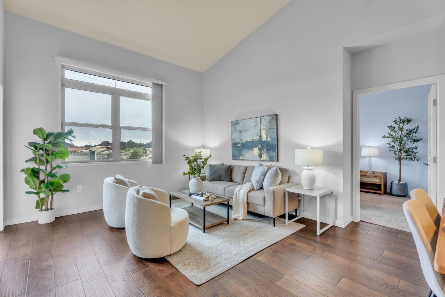 a living room with furniture and a potted plant