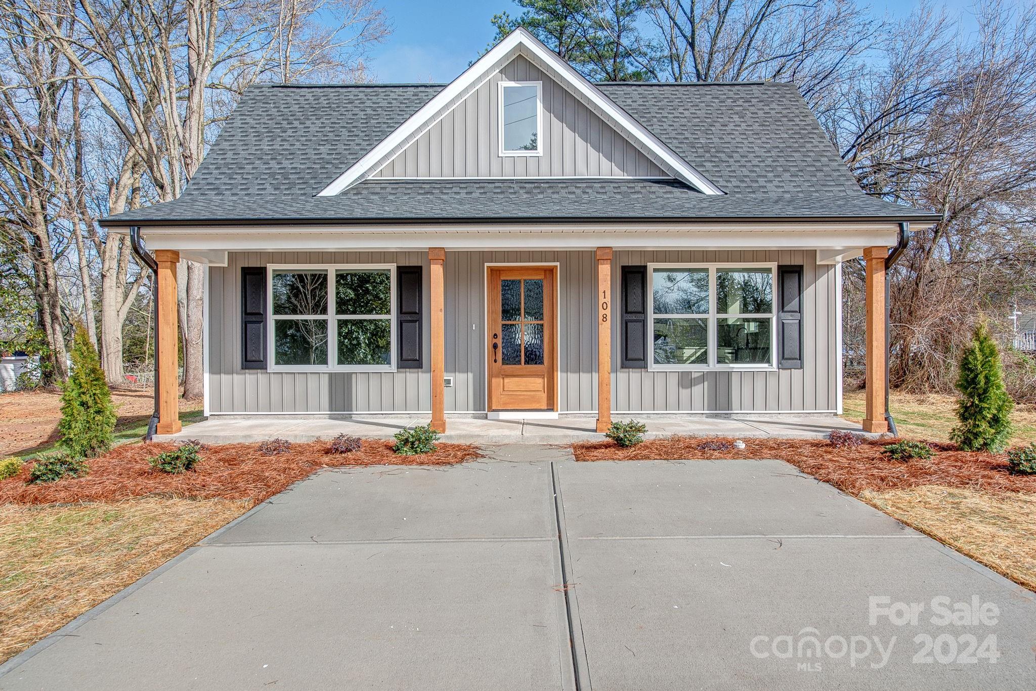 a front view of a house with a yard and outdoor space