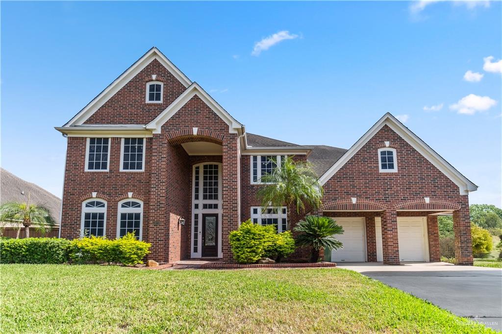 front view of brick house with a yard