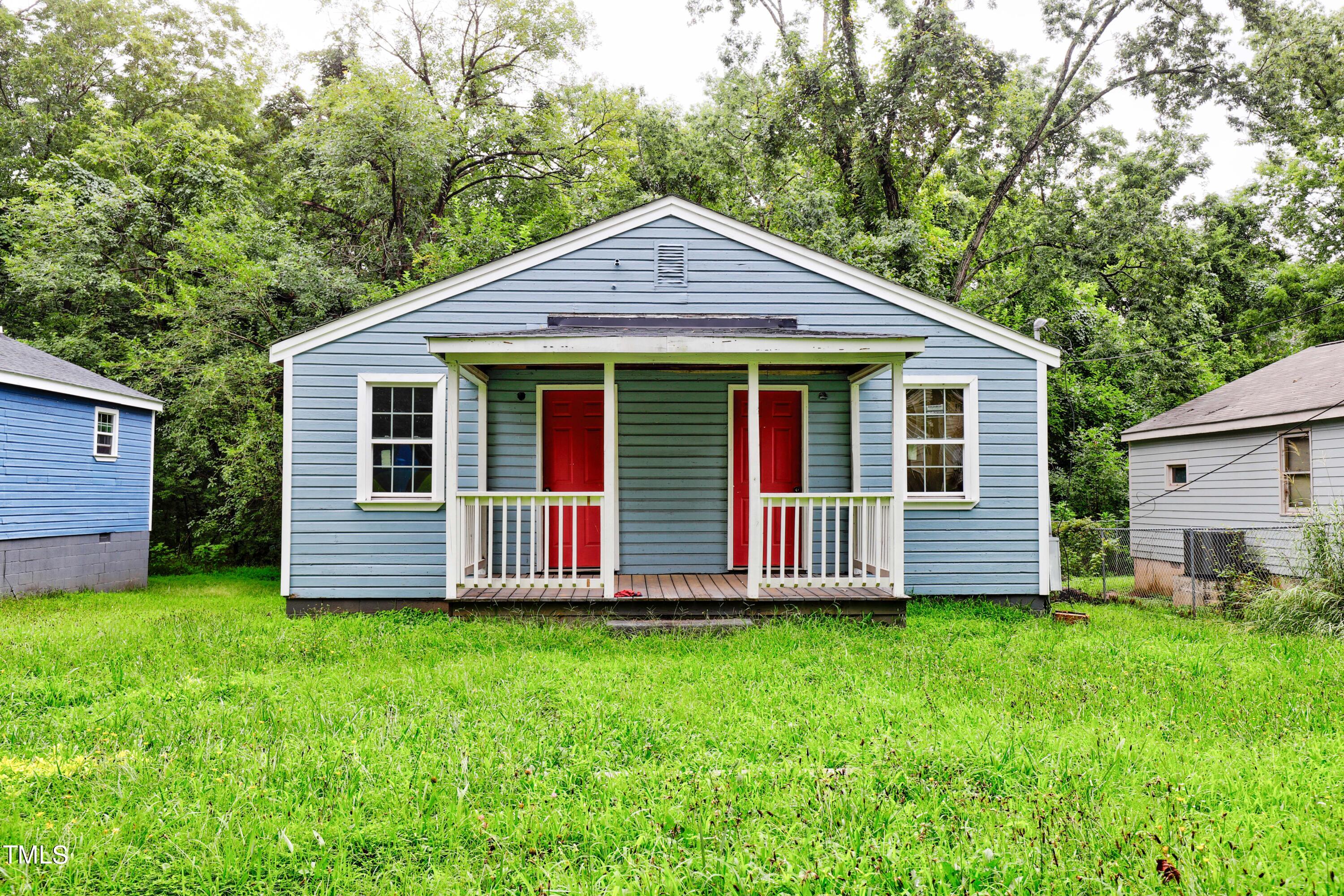 a front view of a house with a yard and fence