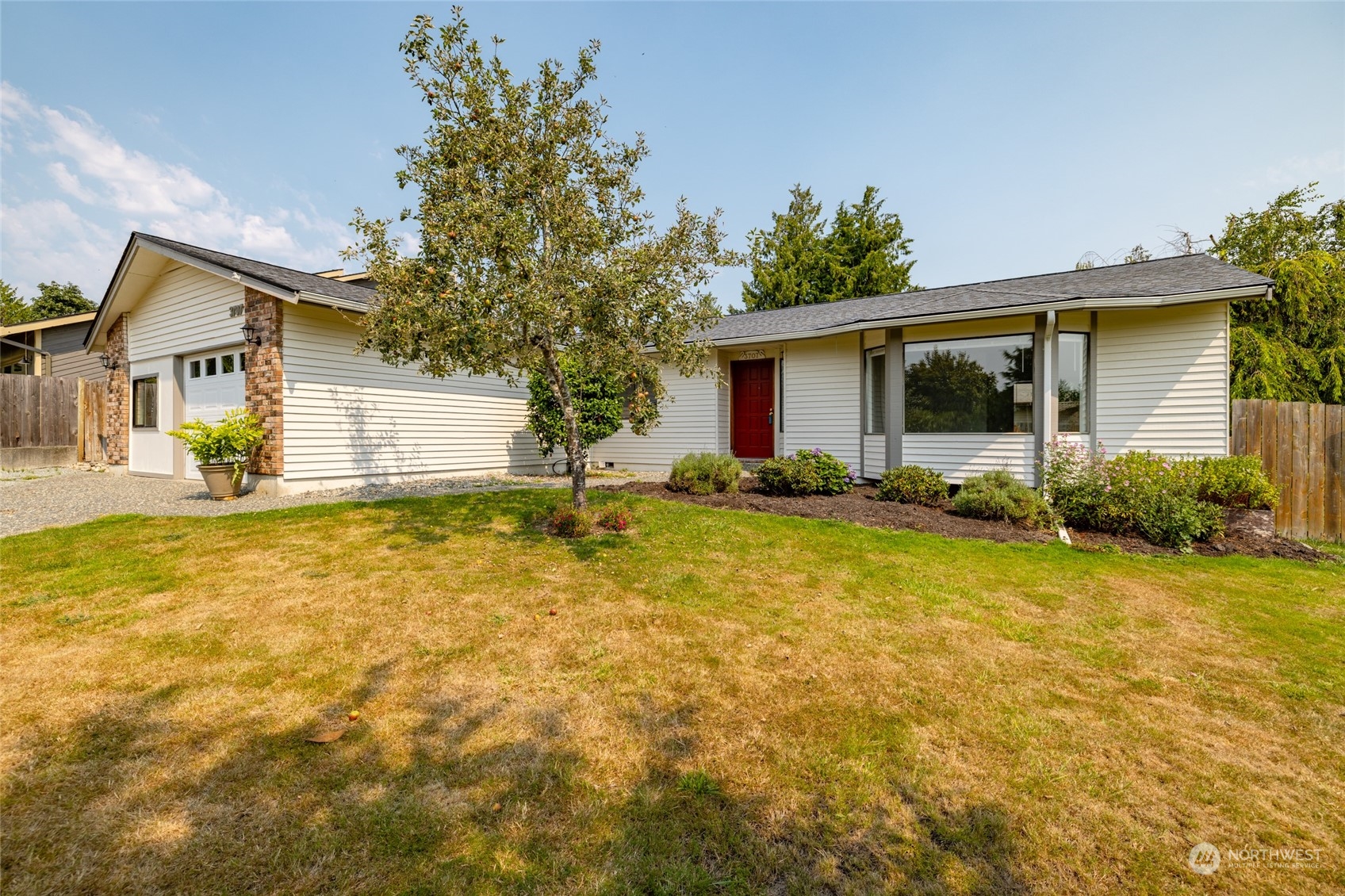 a front view of house with yard and trees around