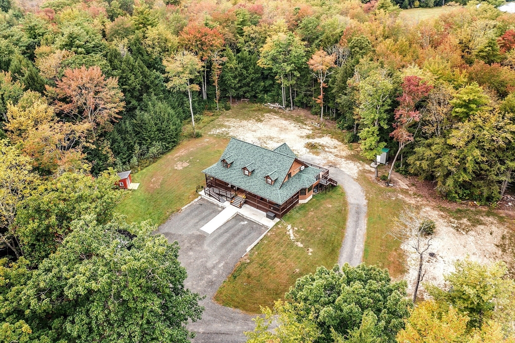 an aerial view of a house with a yard and lake view