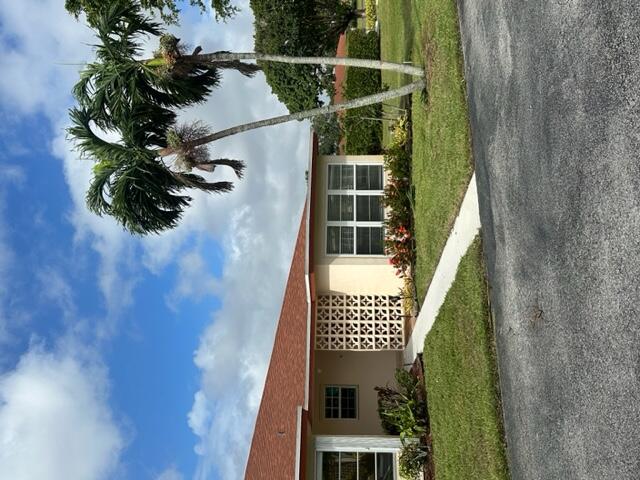 a front view of a house with a garden and yard