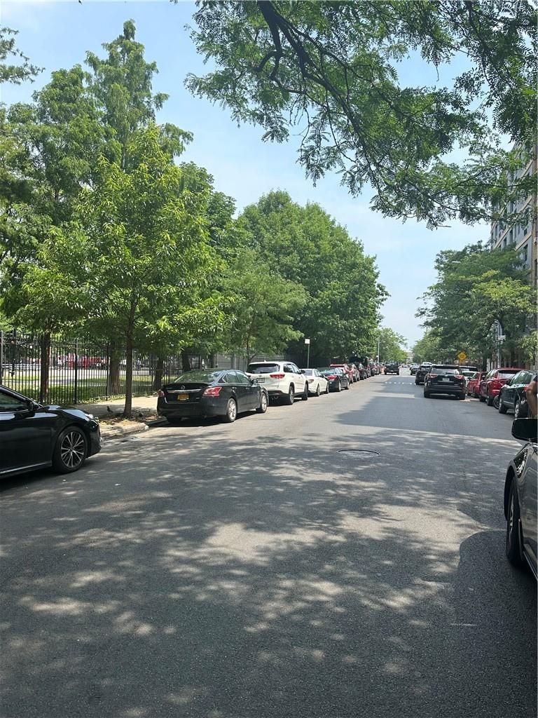 a view of street with parked cars