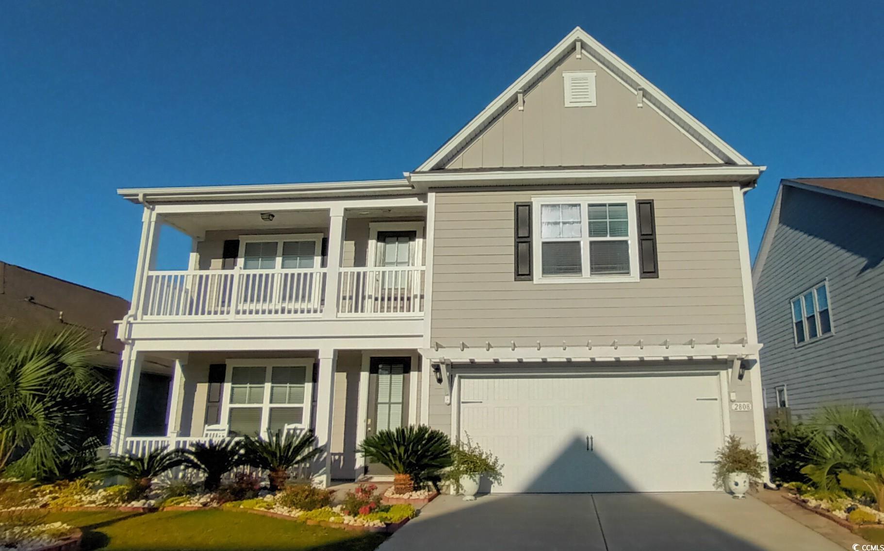 View of front of property featuring a garage and a