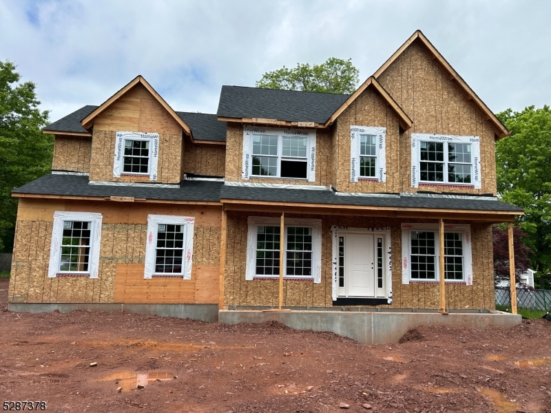 a front view of a house with yard and parking space