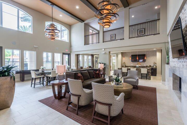 a living room with fireplace furniture and a large window