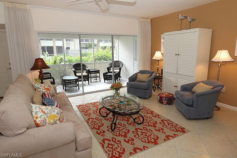 Tiled living room featuring ceiling fan