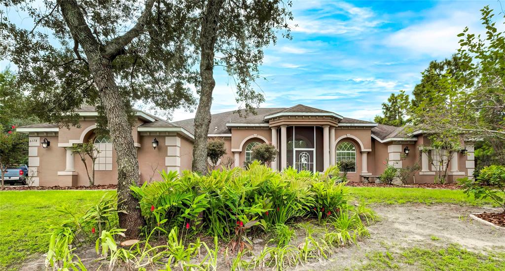 a front view of a house with garden