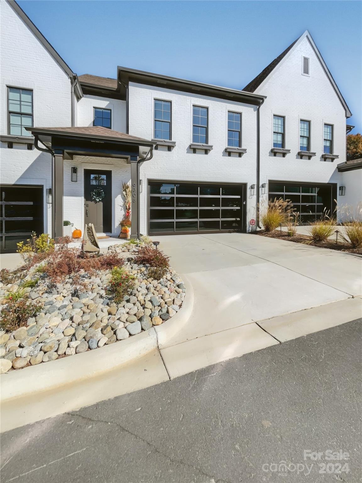 a view of a house with a patio and a yard