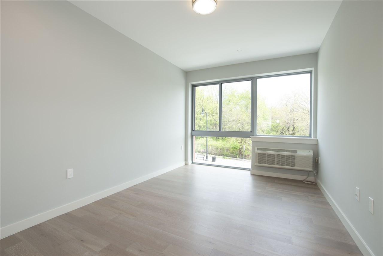 an empty room with windows and city view