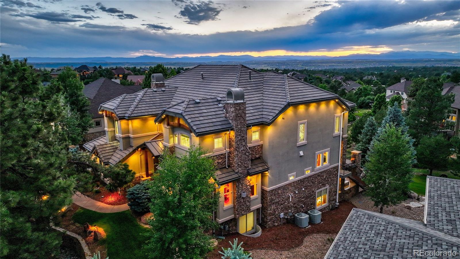 an aerial view of a house with swimming pool and mountain view