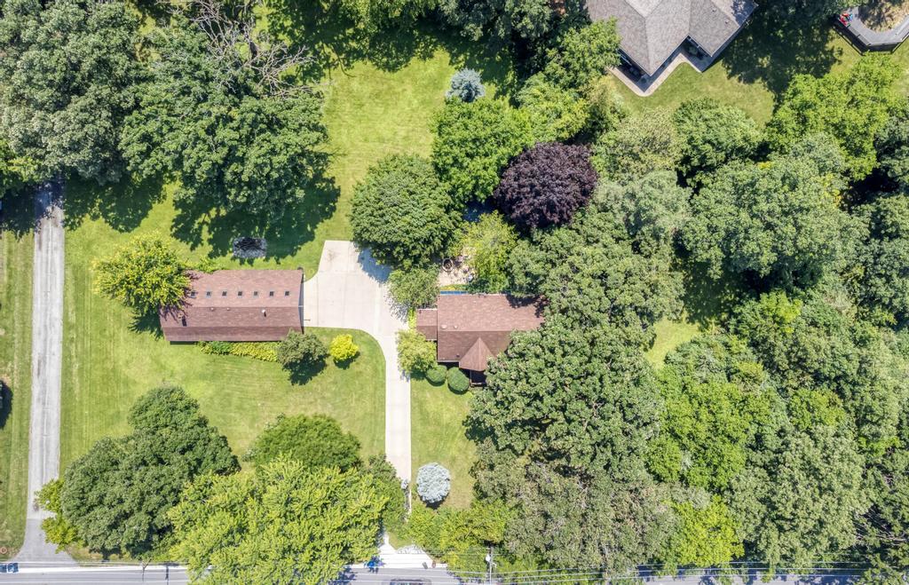 an aerial view of a house with a yard and garden