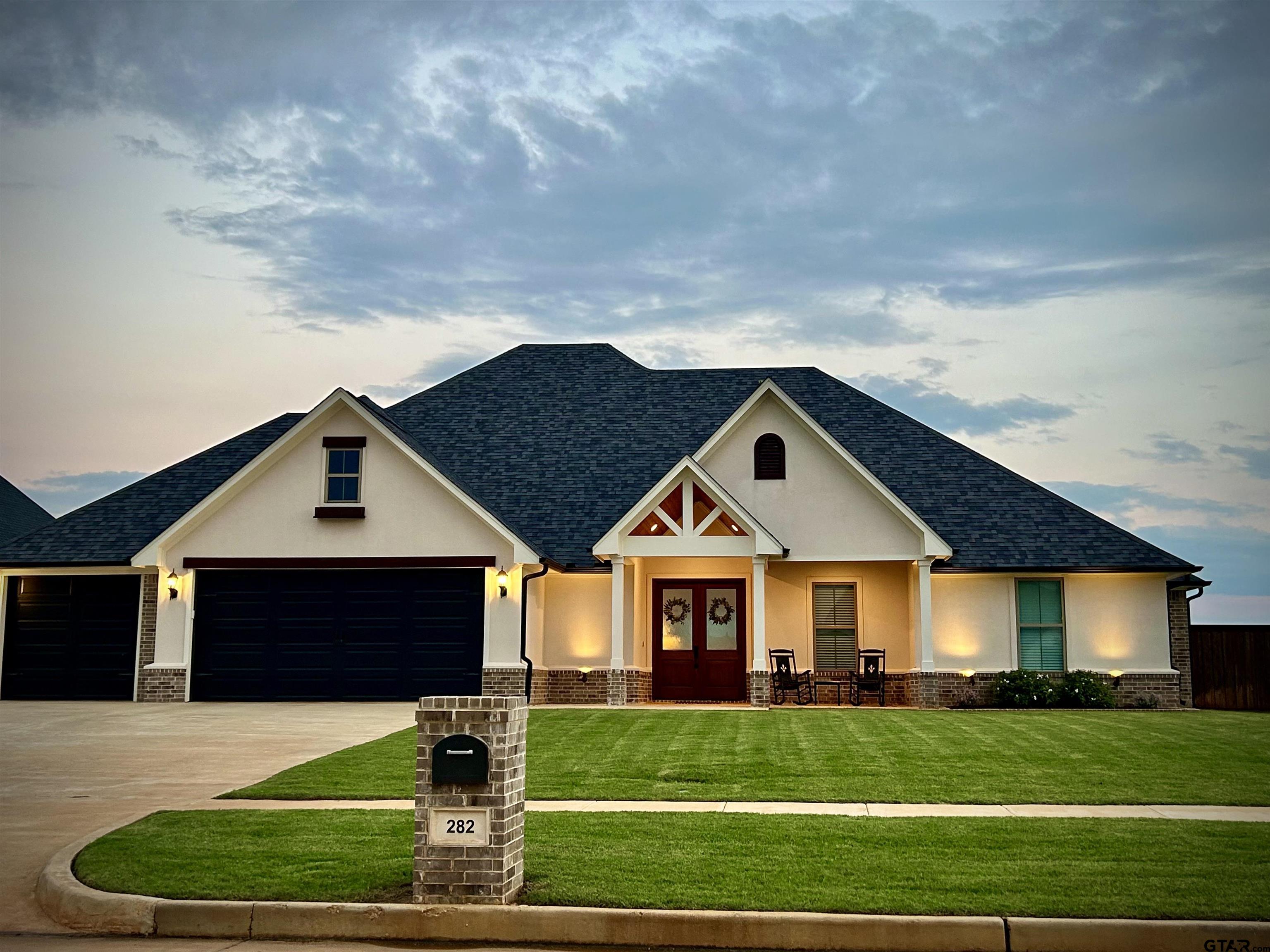 a front view of a house with a yard