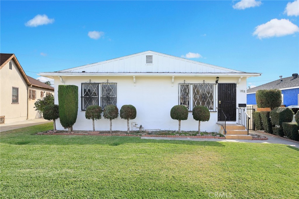 a view of house with backyard space and sitting area