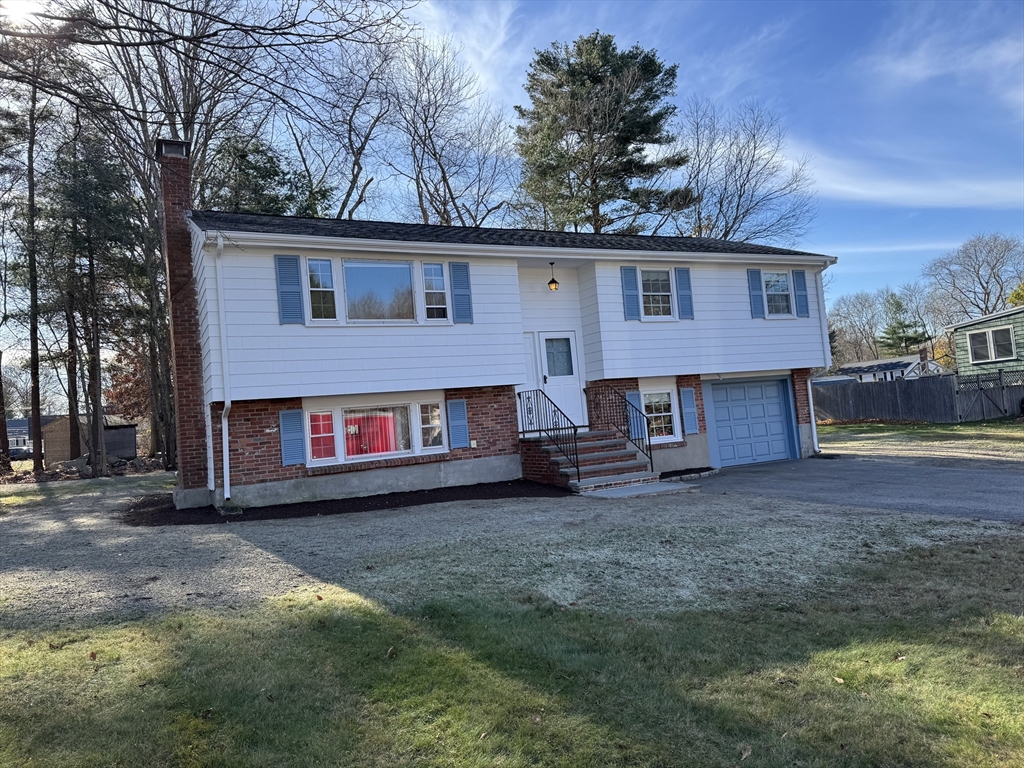 a view of a house with a yard and garage