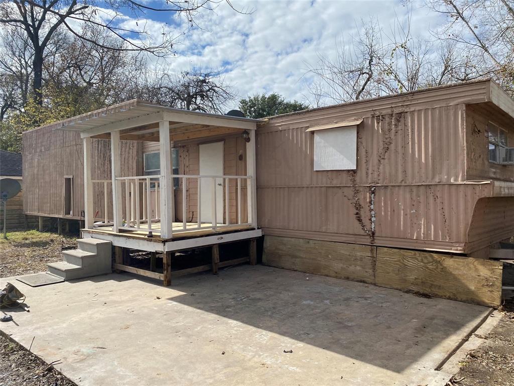 a view of a house with a yard and wooden fence