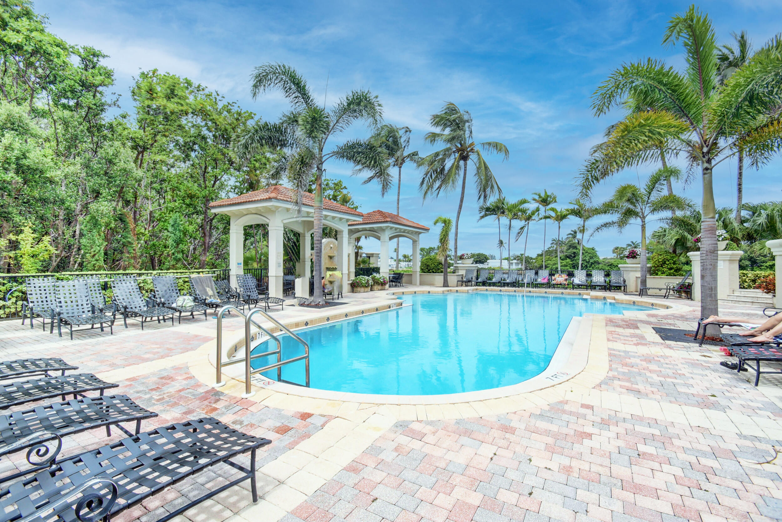 a view of a swimming pool with lounge chairs