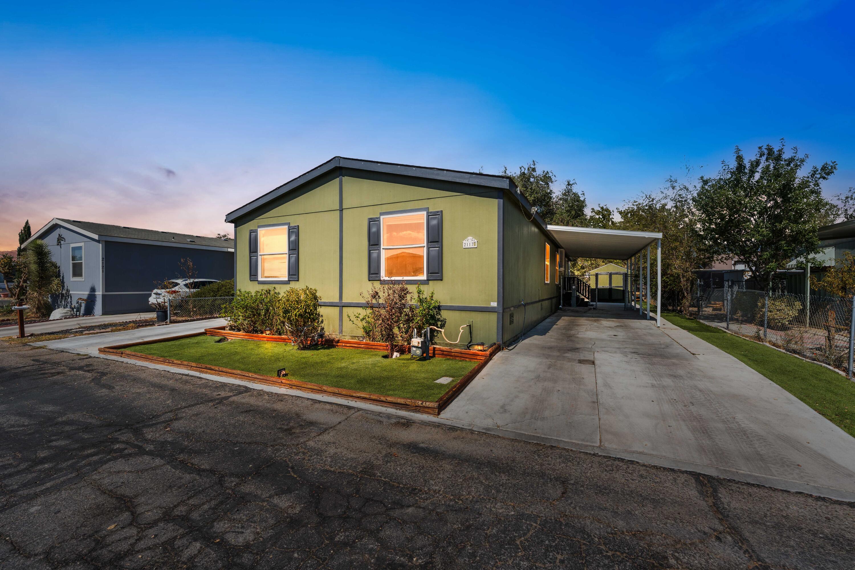 a front view of a house with a yard garage and outdoor seating