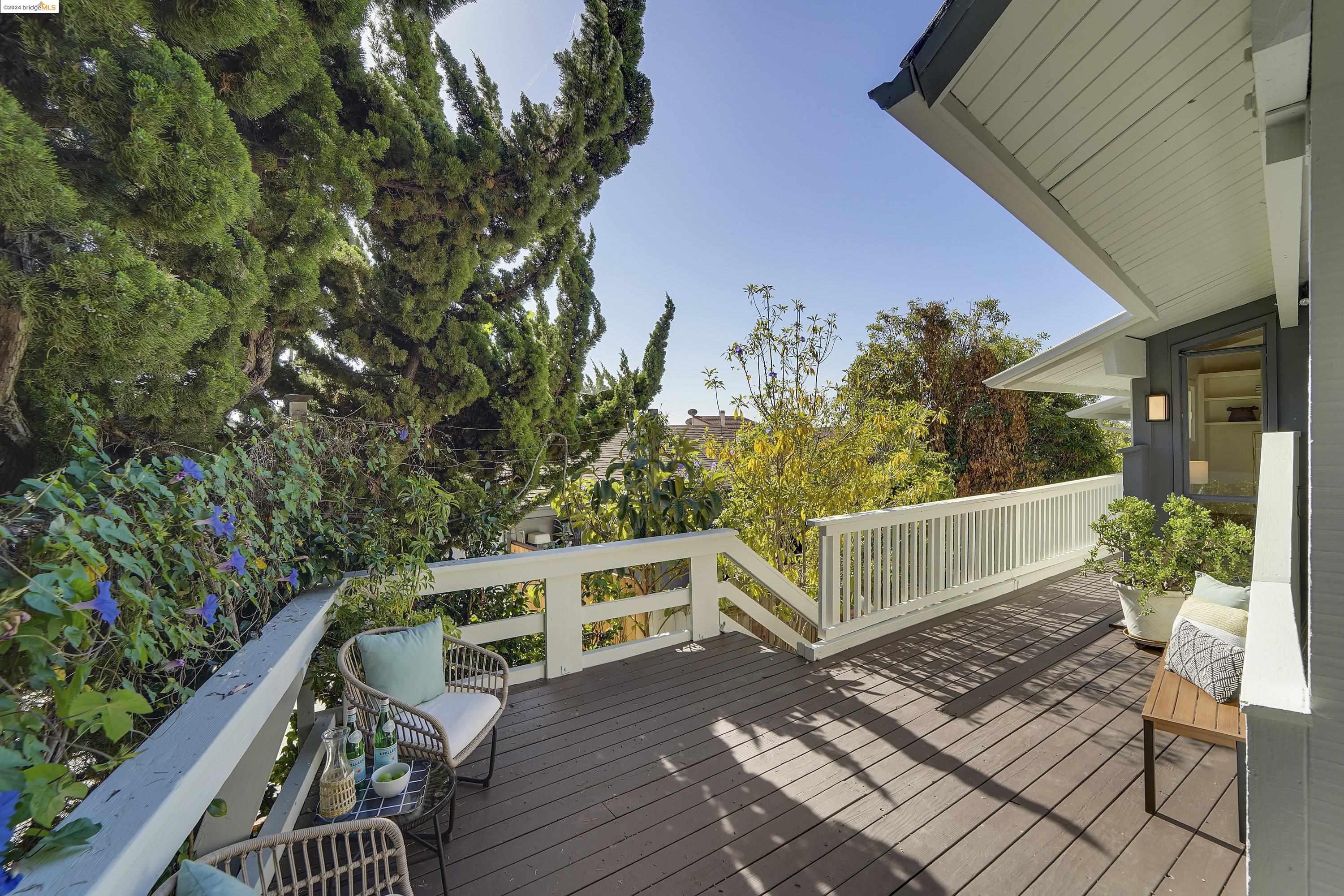 a view of deck with seating and trees