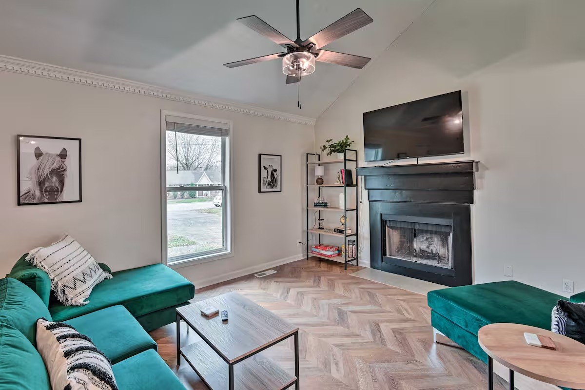 a living room with furniture a flat screen tv and a fireplace