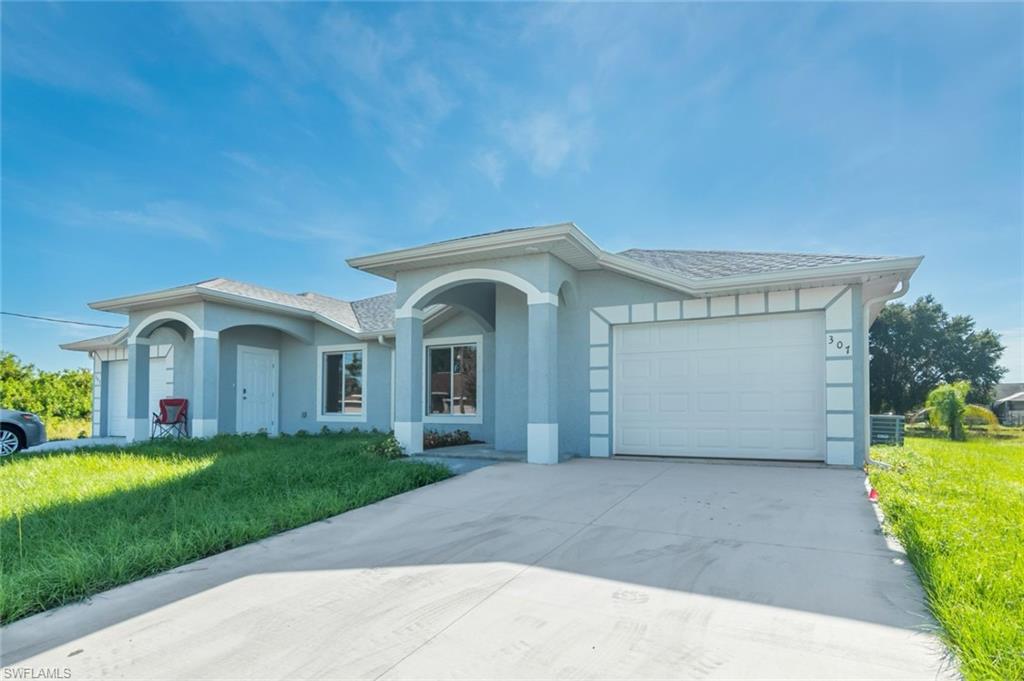 a front view of a house with a yard and garage