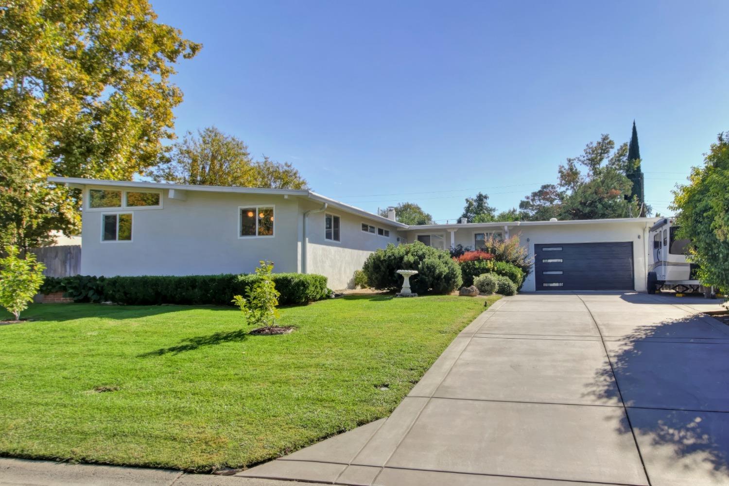 a front view of house with yard and green space