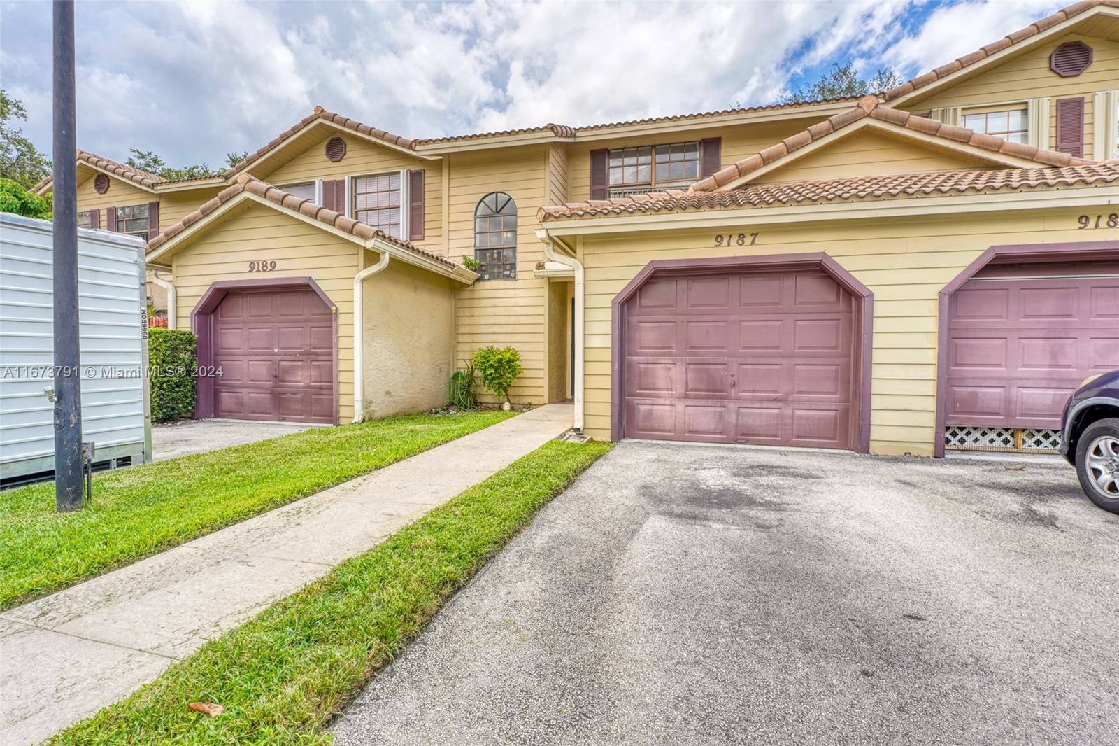 a front view of a house with a yard and garage