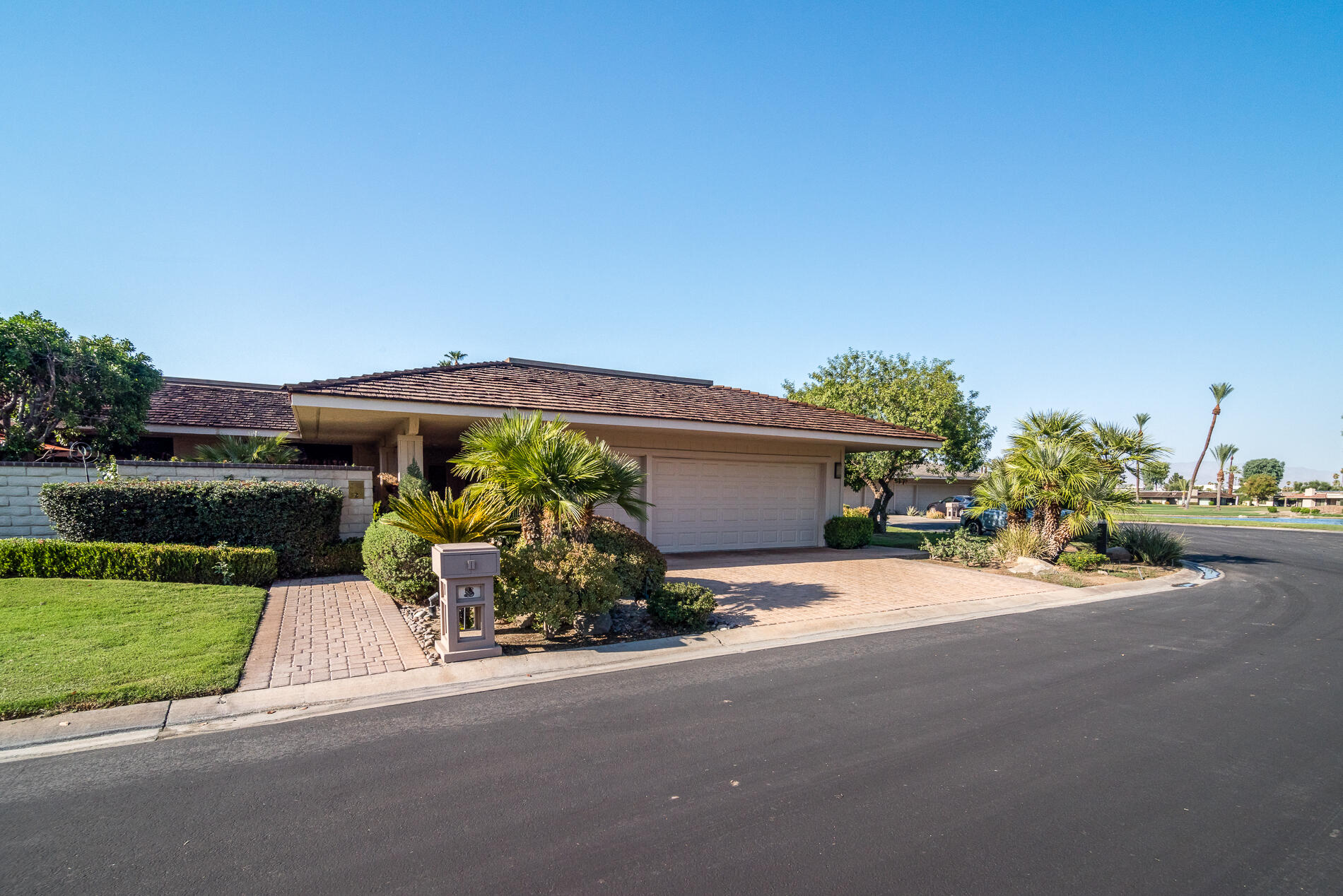 a front view of a house with a yard and outdoor seating