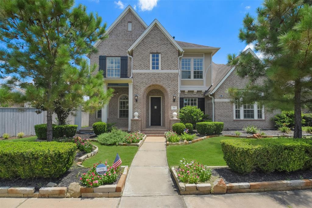 a front view of a house with yard and green space