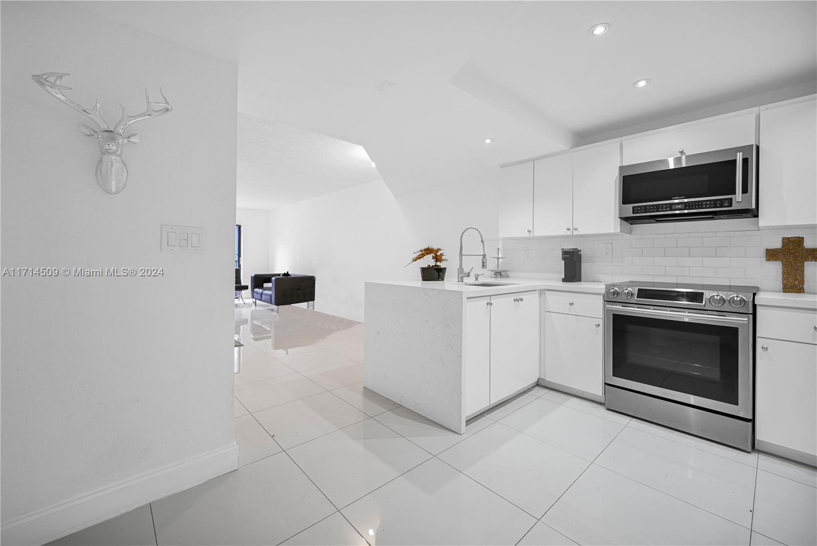 a kitchen with a sink and steel appliances