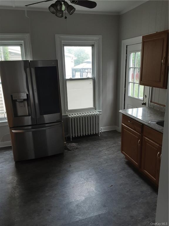 a kitchen with stainless steel appliances granite countertop a refrigerator and a sink