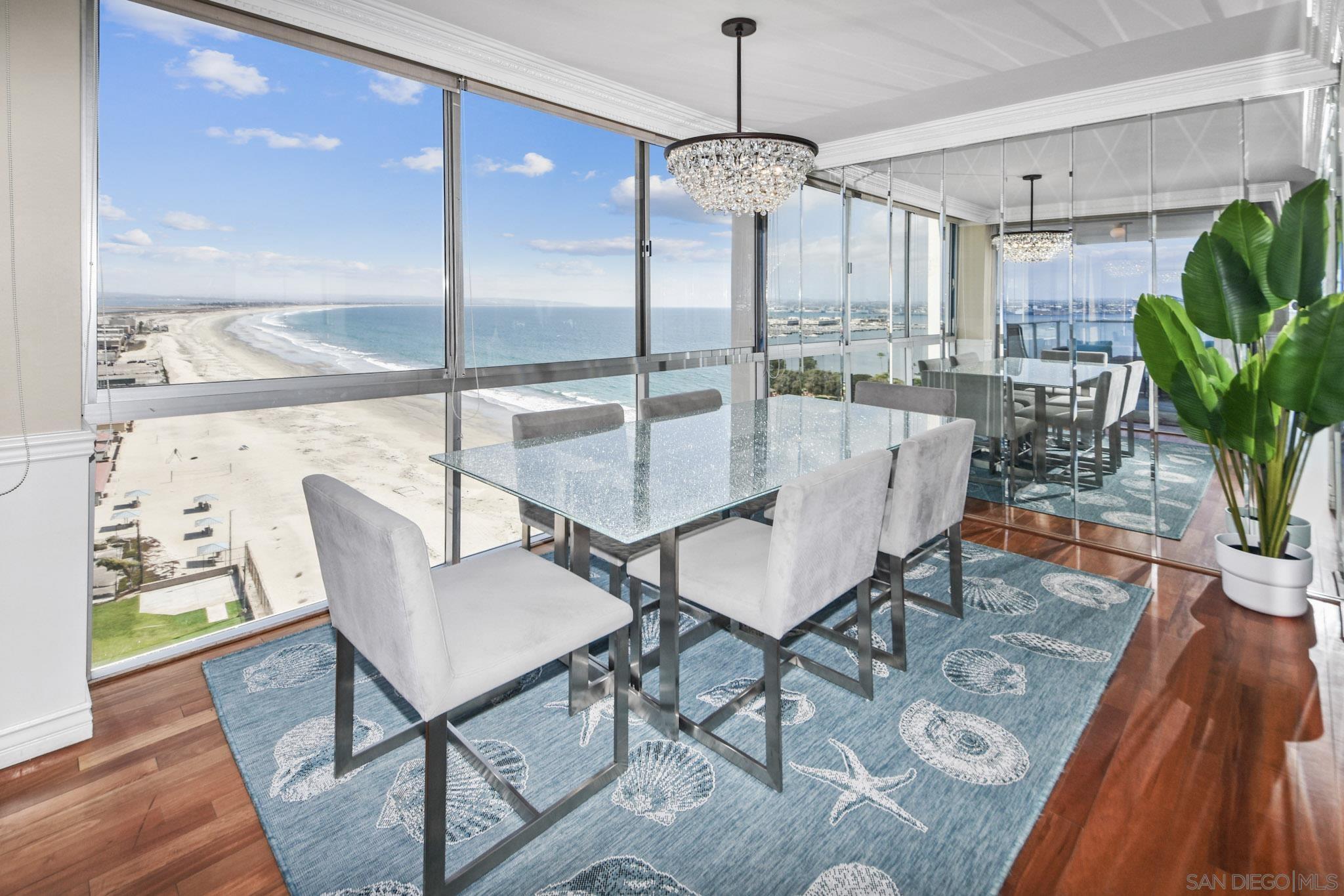 a dining room with furniture a chandelier and wooden floor