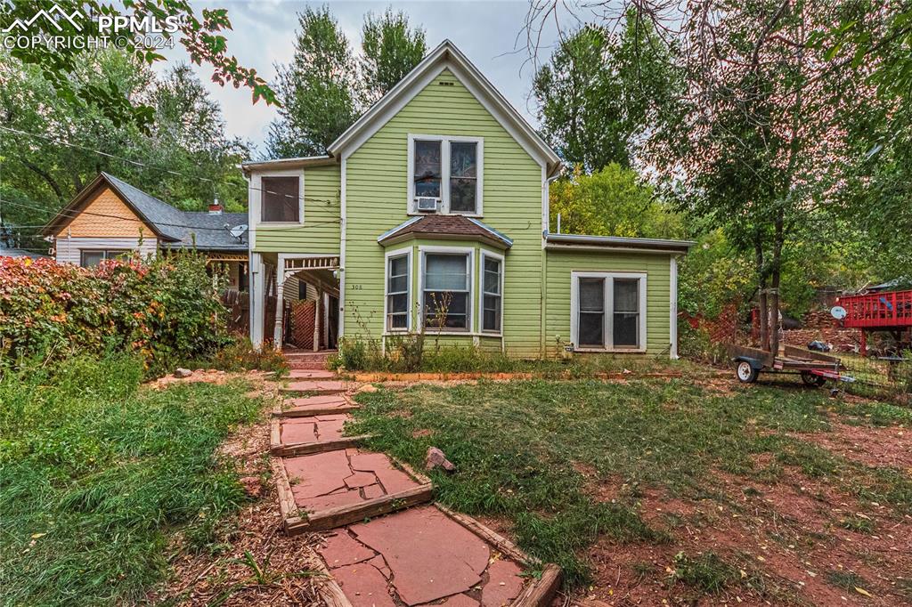 a front view of a house with a yard and porch