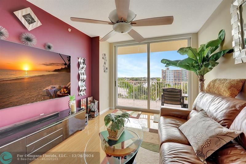 a living room with furniture and a floor to ceiling window