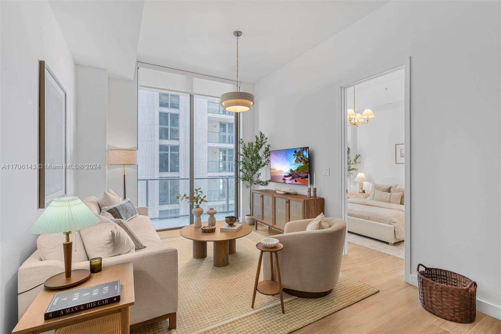 a living room with furniture and a chandelier