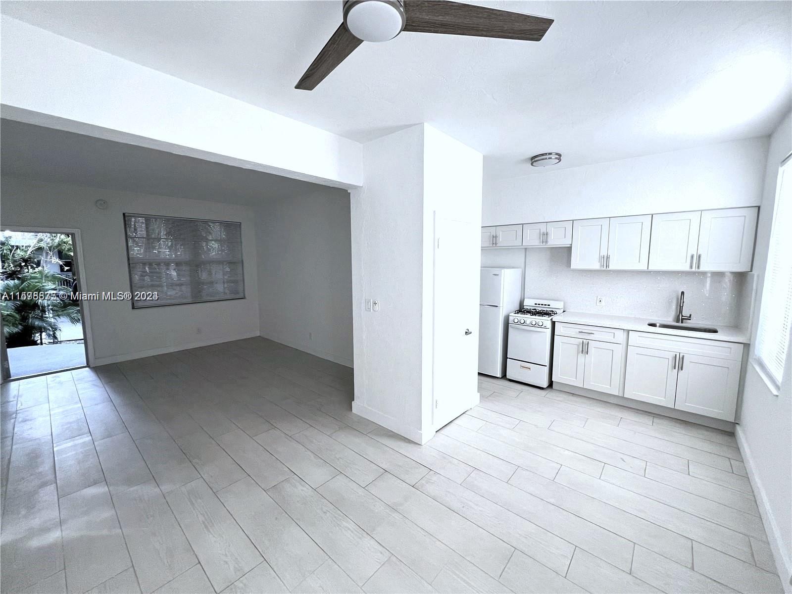 a view of a kitchen with electric appliances