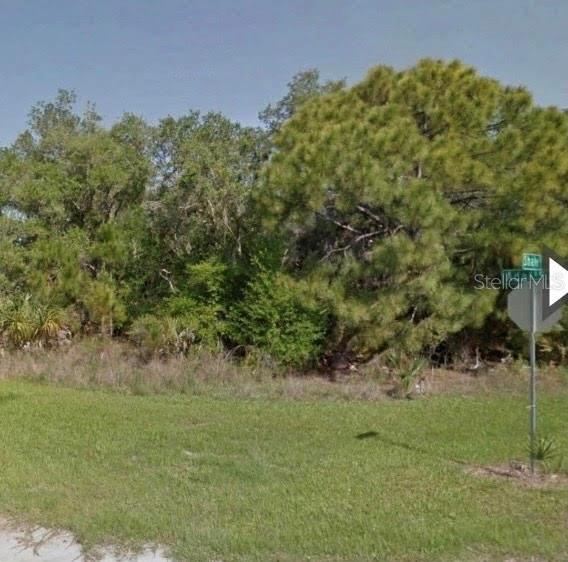 a view of a green field with lots of bushes