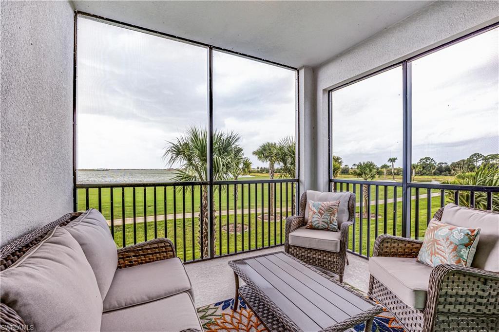 a balcony with furniture and floor to ceiling window